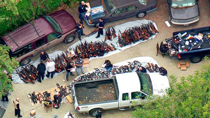 Investigators from the U.S. Bureau of Alcohol, Tobacco, Firearms and Explosives and the police inspecting a large cache of weapons seized at a Bel Air mansion. Photo / AP