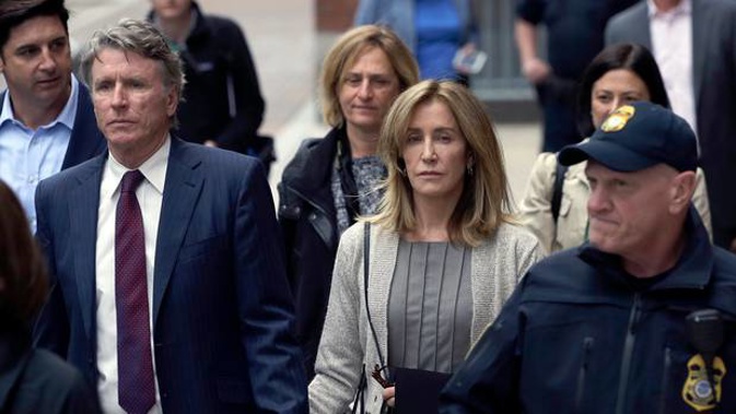 Felicity Huffman departs federal court with her brother Moore Huffman Jr on Monday, May 13 in Boston. (Photo / AP)