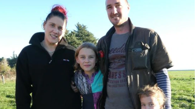 The Mielnik family, of Ashburton, say an armed police raid of their home was "heavy-handed''. Pictured are Adam Mielnik and fiancee Tara Pope, and children Ella and Sacha. (Photo / Supplied)
