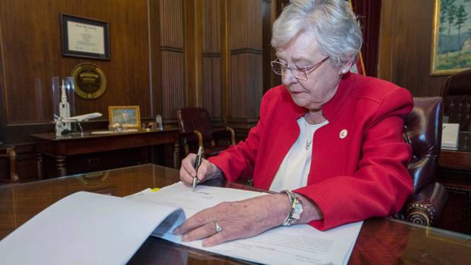 Alabama Governor Kay Ivey signing a bill that virtually outlaws abortion in the state. (Photo / AP)