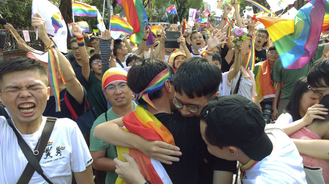 Supporters of the legislation celebrated outside the Taiwanese Parliament. (Photo / AP)