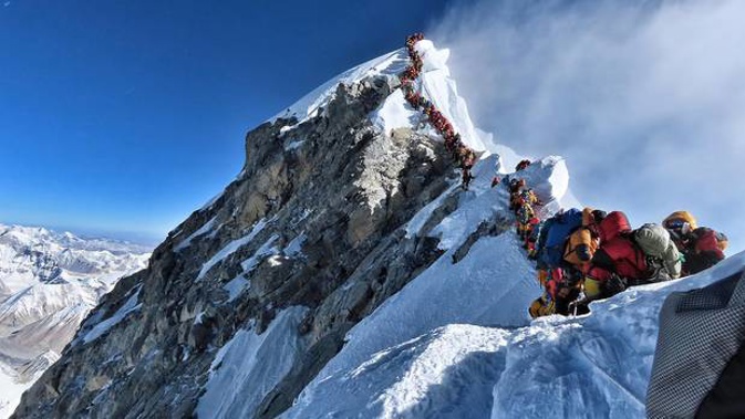 Handout photo taken on May 22, 2019, and released by climber Nirmal Purja's Project Possible expedition shows heavy traffic of mountain climbers lining up to stand at the summit of Mount Everest.