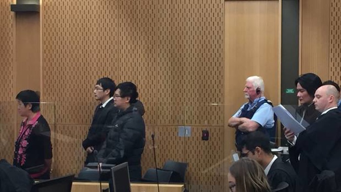 Four people charged with synthetic drug dealing are standing trial at Christchurch District Court. Fei He, Xiwen Miao, Heng Fu and Sui Jun Zhou (second from far right) deny the charges. (Photo / Kurt Bayer)