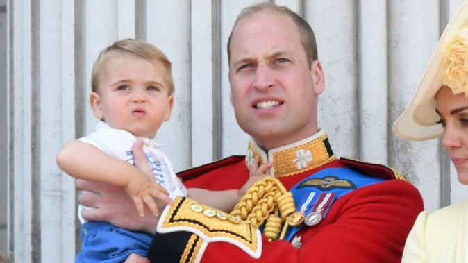 Prince Louis watches the festivities in the arms of his father William. (Photo / Getty)