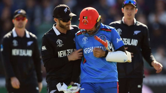 Kane Williamson of New Zealand checks Rashid Khan of Afghanistan after he was struck on the head and dismissed. Photo / Getty