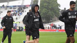 The Black Caps run from the field during rain. Photo / Photosport