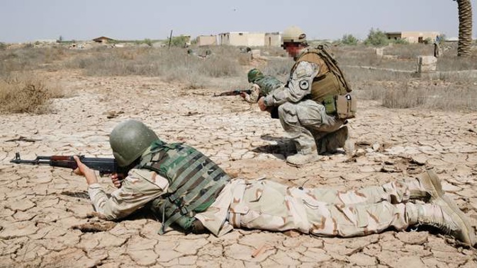 A New Zealand Defence Force trainer instructs ISF soldiers in correct weapons firing positions in Taji, Iraq. Photo / File