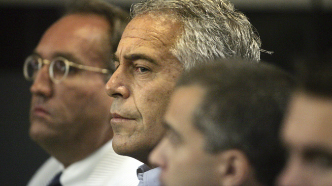 In this July 30, 2008 file photo, Jeffrey Epstein, centre, is shown in custody in West Palm Beach. (Uma Sanghvi/Palm Beach Post via AP, File)
