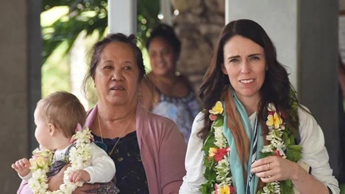 Jacinda Ardern at Rarotonga International Airport with Akaiti Puna, the wife of prime minister Henry Puna, and baby Neve. (Photo / Cook Islands News)
