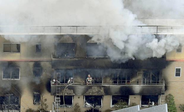 Firefighters work as smoke billows from a three-story building of Kyoto Animation in a fire in Kyoto, western Japan. Photo / AP