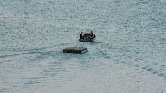 Police have posted this image of a pontoon being stolen on Waiheke Island in June. (Photo / NZ Police Facebook)