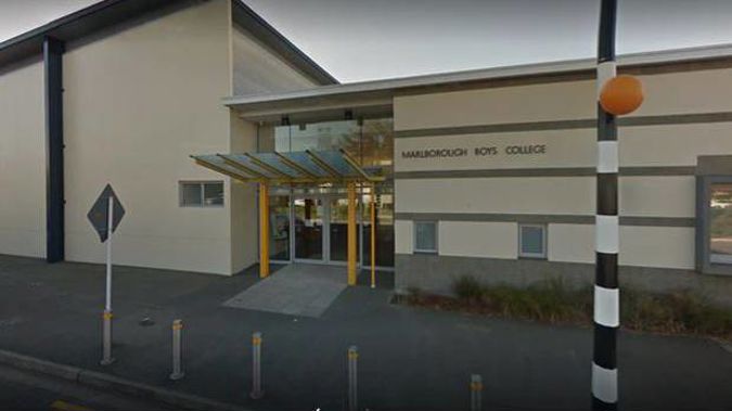 A woman has been charged as part of an ongoing investigation into sexual allegations at Marlborough Boys' College.