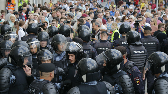 Russian police block a street during an unauthorised rally. (Photo / AP)