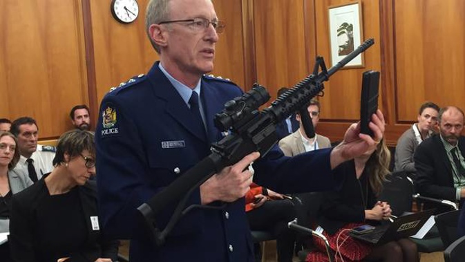 Police acting superintendent Mike McIlraith demonstrates to a select committee in Parliament the types of weapons and magazines that will be banned under the new firearms legislation. Photo / Jason Walls