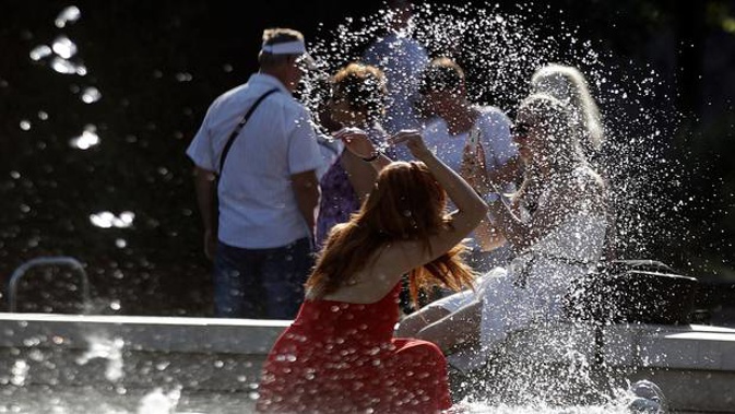 A woman cools off in a public fountain in front of the Sforza Castle in Milan, Italy as Europe's heatwave continued in July. Photo / AP