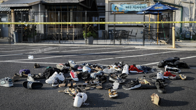 Shoes piled outside the bar where nine people were shot and killed. (Photo / AP)