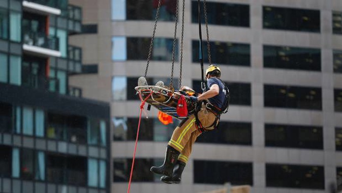 The injured man was hoisted to an ambulance by a crane. (Photo / Dean Purcell)