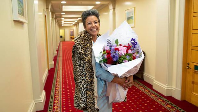 National Party deputy leader Paula Bennett with a larger bunch of flowers than those she sent to Winston Peters. (Photo / Mark Mitchell)