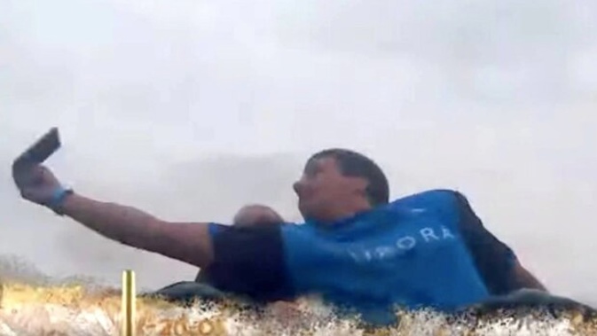 Footage of the Kiwi man catching the phone has gone viral. (Photo / YouTube)