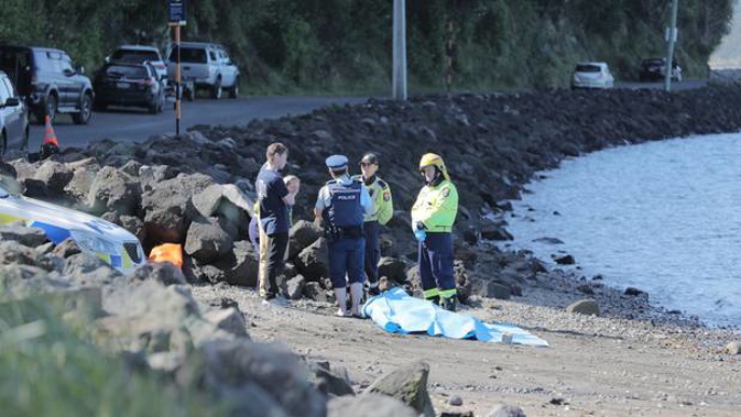 Police at Little Huia. A person has died and two people were rescued after a boat flipped while trying to cross the Manukau Bar today. (Photo / Michael Craig)
