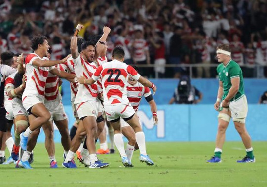Japan's players celebrate after defeating Ireland 19-12. Photo / AP