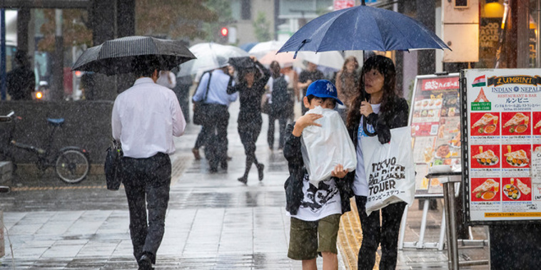 Tokyo locals braving the rain on Friday, 24 hours before Typhoon Hagibis will make its full impact felt. (Photo / Mark Mitchell)