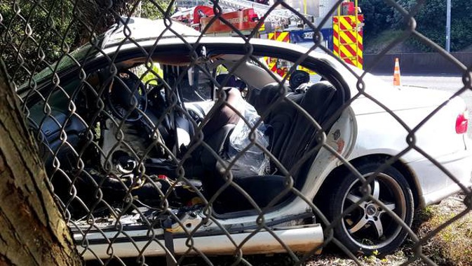 Emergency services used the jaws of life to cut two people from the car. (Photo / Supplied)