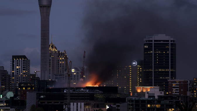 The fire is more visible from a street level now that it is darker. (Photo / NZ Herald)