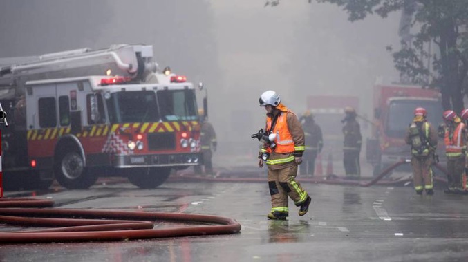 Firefighters on the ground at the scene of the fire. (Photo / NZ Herald)
