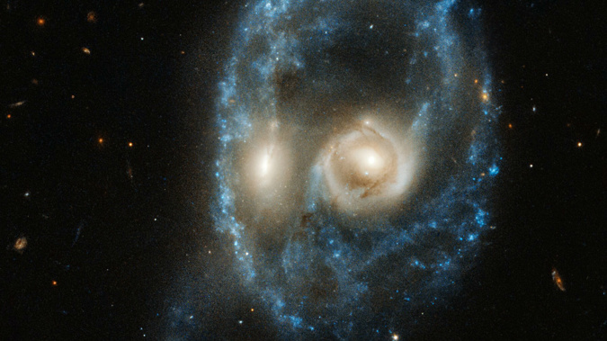 This new image from the NASA/ESA Hubble Space Telescope captures two galaxies of equal size in a collision that appears to resemble a ghostly face.