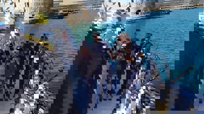 The Greek coastguard help a New Zealand woman ashore in Crete after she was found afloat in a dinghy in the Aegean sea on Sunday morning. Photo / Crete Live