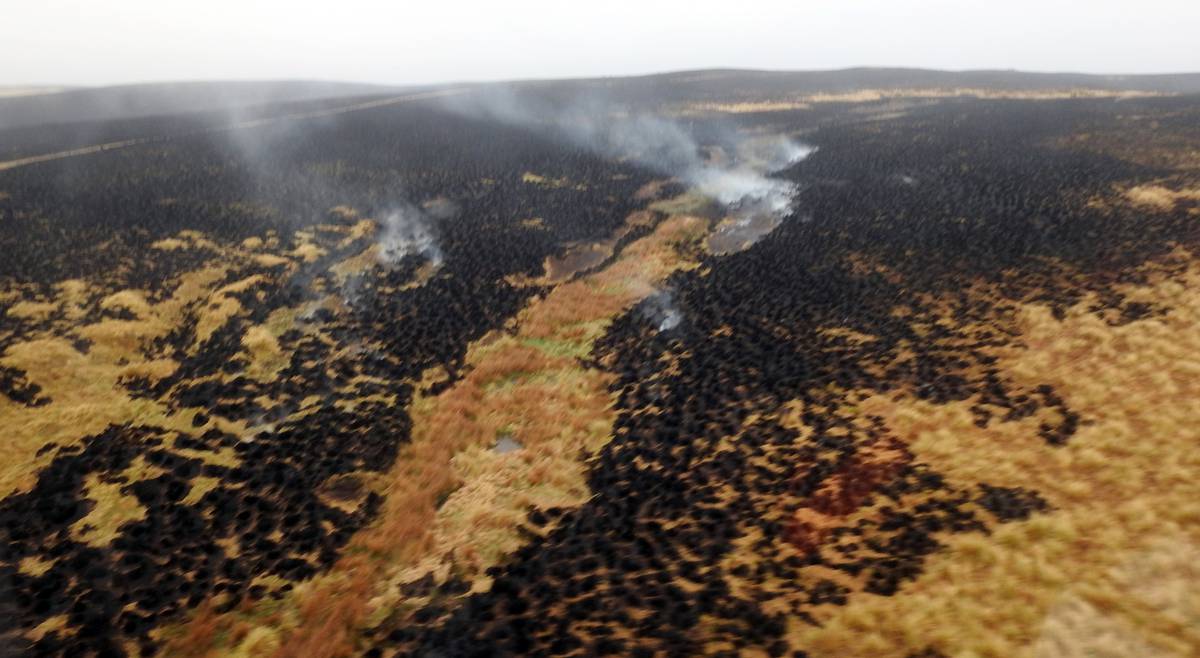 Hotpots could be seen smouldering at the site on Sunday. (Photo / Fire and Emergency NZ)