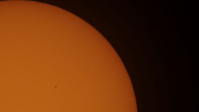 Mercury, center left, passes between Earth and the sun. Photo / AP