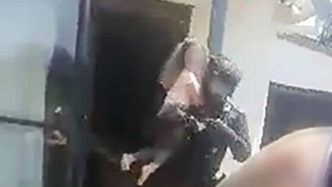 The moment an armed offenders squad member rescues one of two children who had been held hostage for 15 hours.