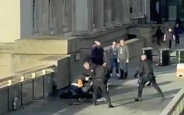 Khan is surrounded by armed police after an incident on London Bridge. (Photo / AP)