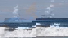 Plumes of steam rise above White Island off the coast of Whakatane. Photo / AP