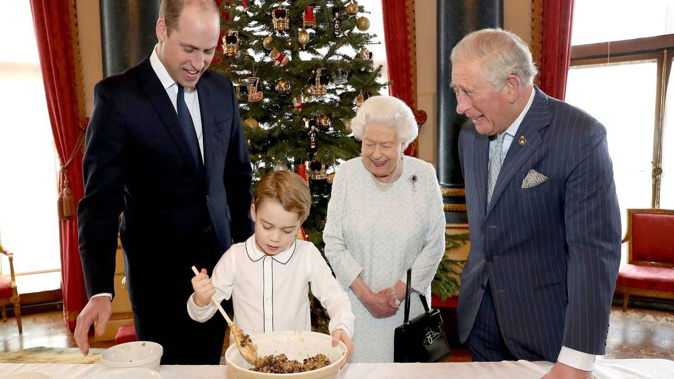 Britain's Queen Elizabeth, Prince Charles, Prince William and Prince George prepare special Christmas puddings. (Photo / AP)