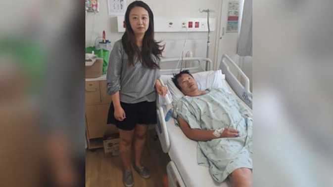Liz and Kyungjin Jeong, who was knocked unconscious in a road rage attack, at North Shore Hospital. Photo / Supplied