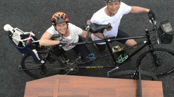 Riding in tandem with a coffin in tow to collect signatures to present to Parliament are Camilla and Julian Cox, of Dunedin. Photo: Gerard O'Brien