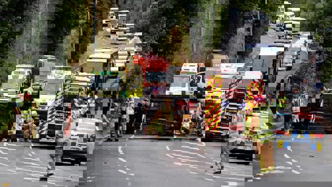Emergency services work to cut an injured person from the wreckage of a crash in Queenstown this morning. Photo / James Allan.