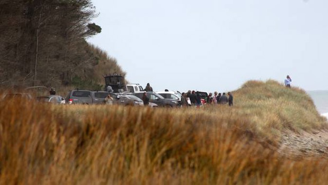 Family and friends gather on the coastline during the search for the missing father and son. (Photo / Wairarapa Times Age)