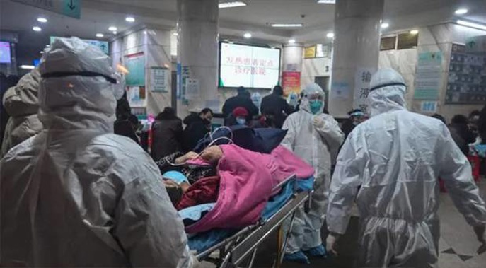 Medical staff wearing protective clothing arrive with a patient at the Wuhan Red Cross Hospital in Wuhan on January 25. Photo / Getty