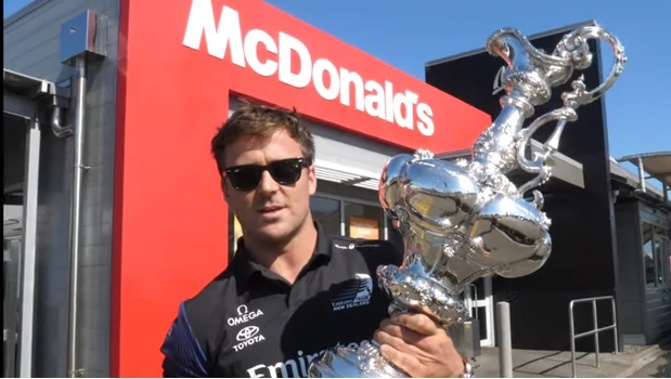 Simon van Velthooven with the America's Cup trophy at the McDonald's in Feilding. Photo / YouTube/EmiratesTeamNZ