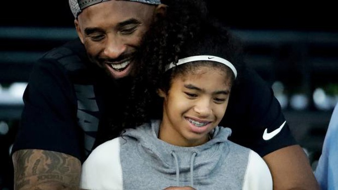 In this July 26, 2018, file photo former Los Angeles Laker Kobe Bryant and his daughter Gianna watch during the U.S. national championships swimming meet in Irvine. (Photo / AP)