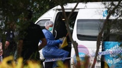 A police forensic officer inspects the minibus in Cairns. (Photo / Supplied)