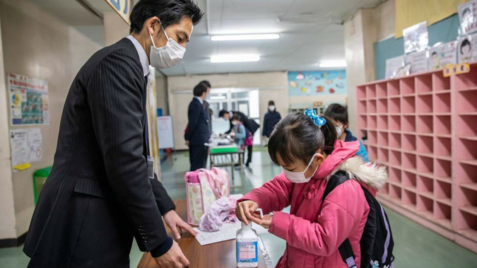 Parents check in their children March 5, 2020, at Kitaurawa Elementary School in Japan's Saitama prefecture. Photo / Shiho Fukada, Washington Post