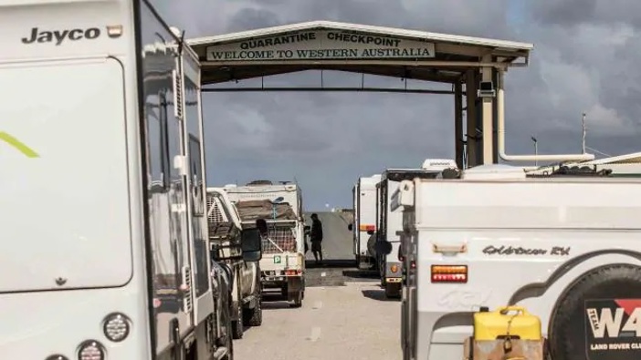 Officials at WA border are work through a 1km-long traffic jam as hundreds of motorists raced to get across before new border restrictions came into force on Sunday.Source:Supplied