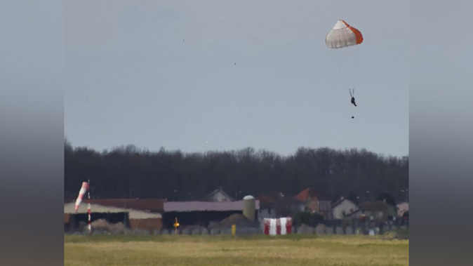 The 64-year-old passenger landed in a field near the German border.