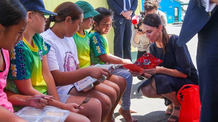 Jacinda Ardern shares a child's free school lunch at Flaxmere Primary School in Hawke's Bay in February. Free lunches will be expanded to 200,000 students by next year. Photo / Hawkes Bay Today