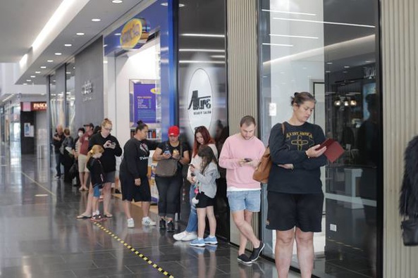 People queuing for a haircut at Northwest Mall. Photo / Dean Purcell